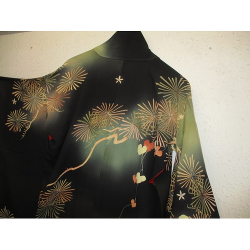 322 - A black silk Japanese kimono. In used condition with a few loose threads and wear. Approximate lengt... 