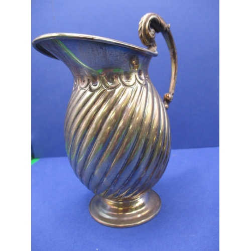 209 - A sterling silver cream jug and a continental example, both in good used condition, approx. gross pa... 