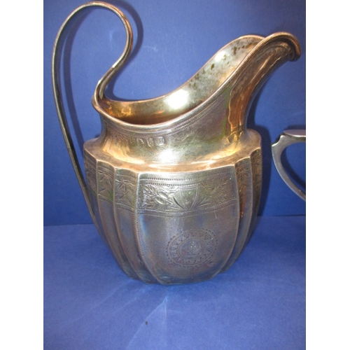 181 - An antique Irish silver cream jug and an arts and craft example by Albert Edward Jones, both in good... 