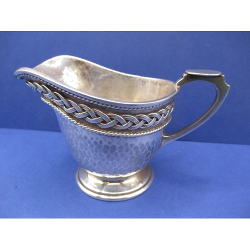 181 - An antique Irish silver cream jug and an arts and craft example by Albert Edward Jones, both in good... 