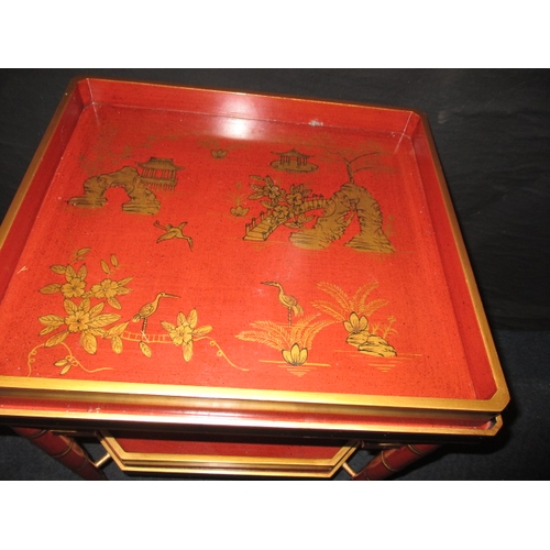 313 - A vintage oriental red lacquer ware two tier tray table, approx. dimensions H: 60cm W: 47cm D: 43cm ... 