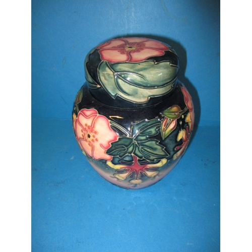 282 - A pair of Moorcroft peacock design vases and a ginger jar in a floral design, all in good used condi... 