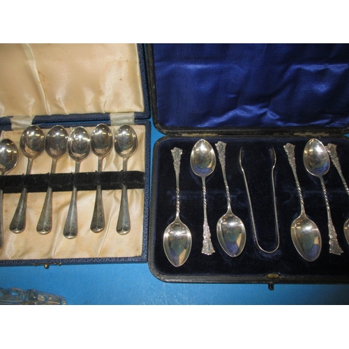 219 - A parcel of silver and white metal items, to include an inkwell and cased sets of spoons, some age r... 