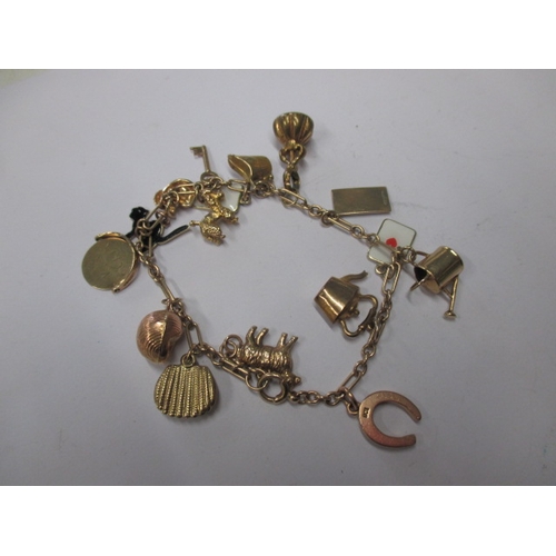 54 - A vintage 9ct gold charm bracelet, in used condition with working clasp, approx. gross parcel weight... 