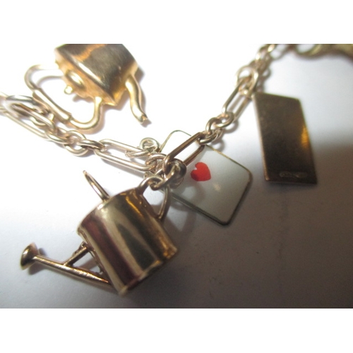 54 - A vintage 9ct gold charm bracelet, in used condition with working clasp, approx. gross parcel weight... 