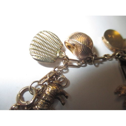 54 - A vintage 9ct gold charm bracelet, in used condition with working clasp, approx. gross parcel weight... 