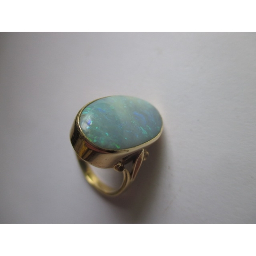 19 - An 18ct yellow gold natural opal ring, approx. ring size ‘M’ approx. stone size 19x11mm, approx. wei... 