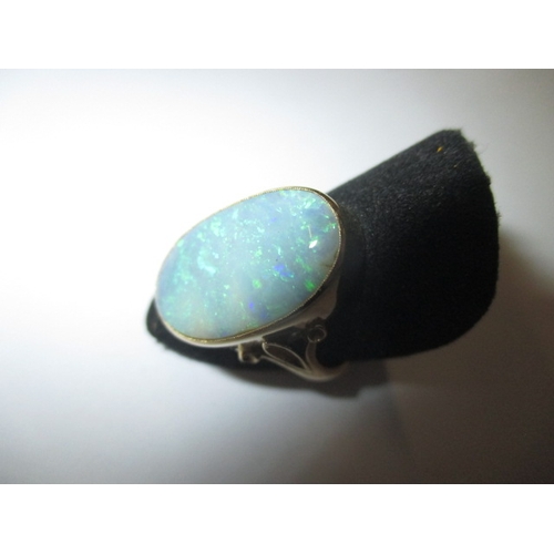 19 - An 18ct yellow gold natural opal ring, approx. ring size ‘M’ approx. stone size 19x11mm, approx. wei... 