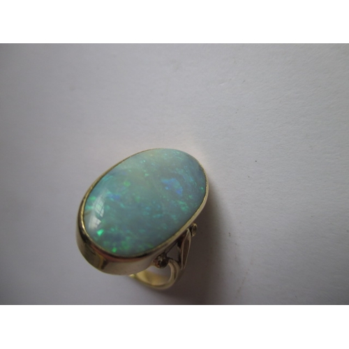 19 - An 18ct yellow gold natural opal ring, approx. ring size ‘M’ approx. stone size 19x11mm, approx. wei... 