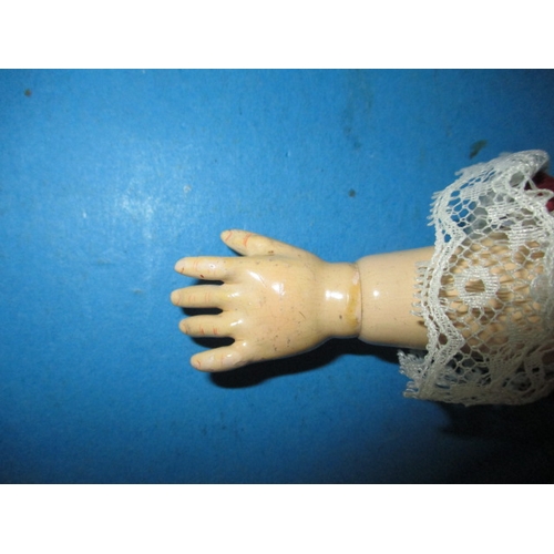 230 - An antique Jumeau? Porcelain head doll, having composite body and later clothes, one finger missing ... 