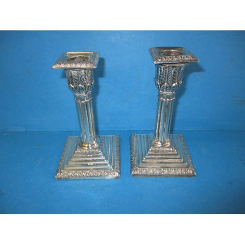 181 - A pair of Edwardian sterling silver candlesticks, approx. height 14cm makers mark T.A.S., in useable... 