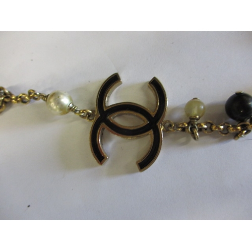 212 - A vintage costume jewellery necklace, in used condition with some enamel loss and use-related marks