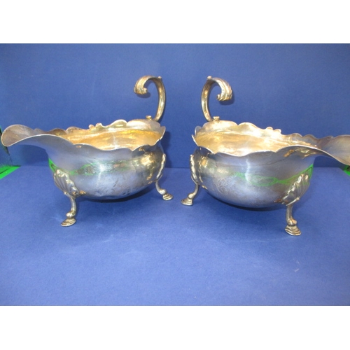 183 - A pair of antique sterling silver sauce boats, both with some minor denting, approx. gross parcel we... 