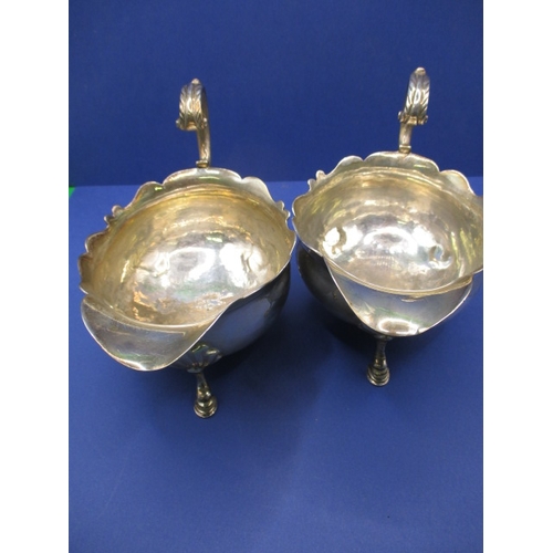 183 - A pair of antique sterling silver sauce boats, both with some minor denting, approx. gross parcel we... 