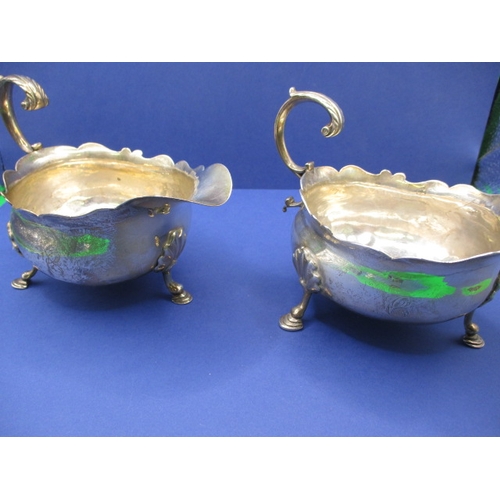 183 - A pair of antique sterling silver sauce boats, both with some minor denting, approx. gross parcel we... 