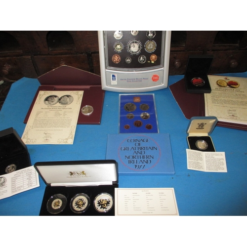 174 - A parcel of mint collectors coins, to include fine silver examples, most with certificates