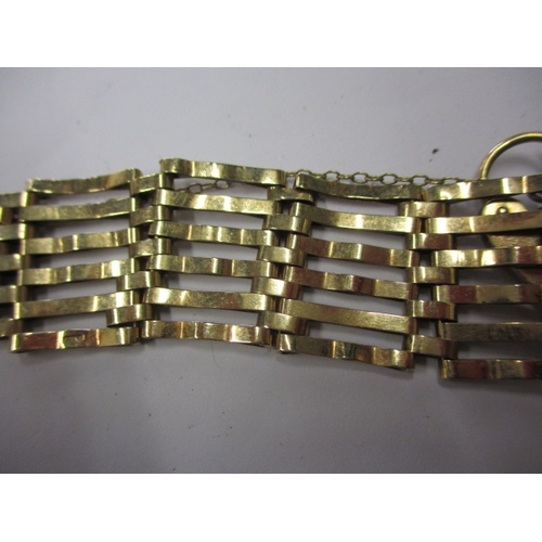 66 - A vintage 9ct yellow gold gate bracelet, in used condition with working clasp and safety chain, appr... 