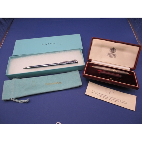 225 - Two propelling pencils, one by Tiffany and Co engraved for Coutts & Co, the other a silver example, ... 