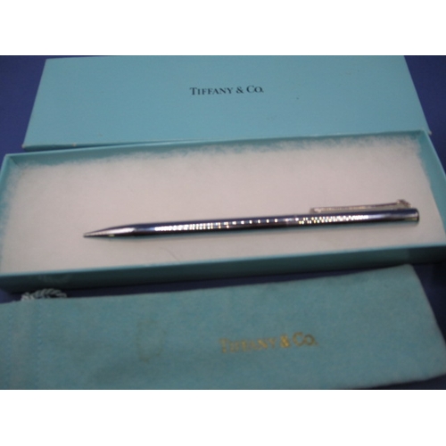 225 - Two propelling pencils, one by Tiffany and Co engraved for Coutts & Co, the other a silver example, ... 