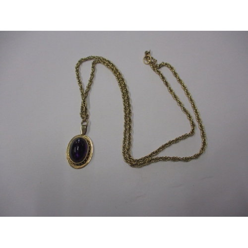 68 - A 9ct yellow gold necklace the pendant set with a cabochon amethyst, approx. chain linear length 48c... 