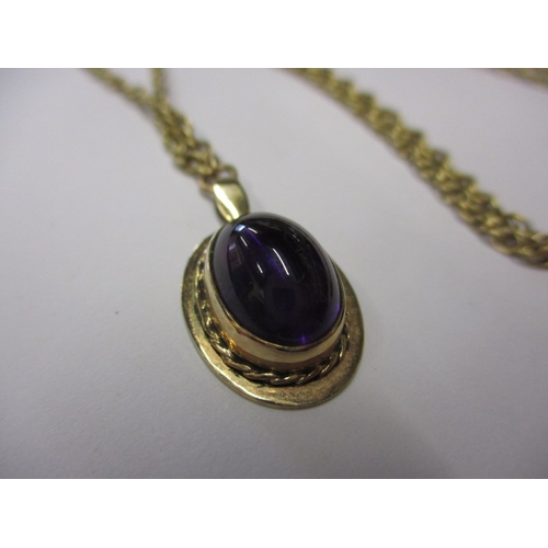 68 - A 9ct yellow gold necklace the pendant set with a cabochon amethyst, approx. chain linear length 48c... 