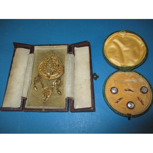 208 - An antique silver gilt brooch and a boxed set of buttons, all in used condition with original boxes