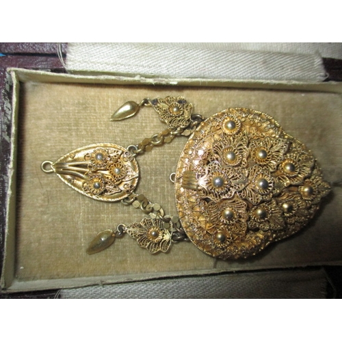 208 - An antique silver gilt brooch and a boxed set of buttons, all in used condition with original boxes