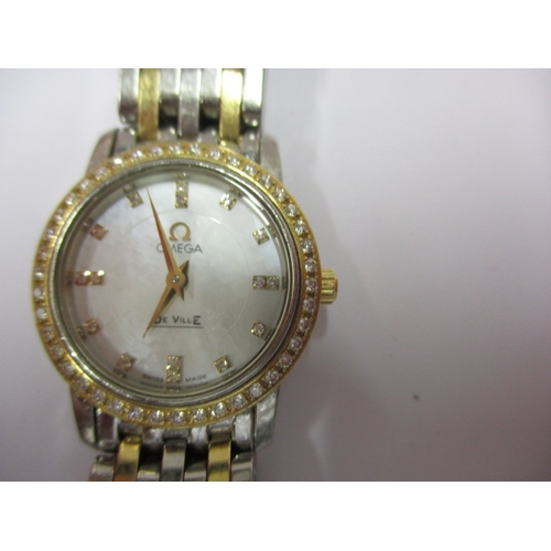 100 - A ladies Omega 1456 wrist watch, having diamond set bezel, in working order with box and all paperwo... 