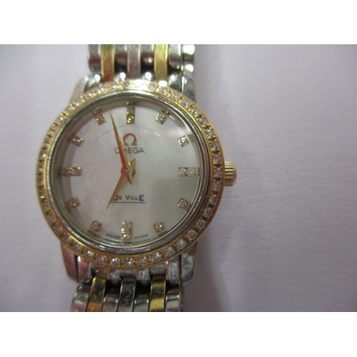 100 - A ladies Omega 1456 wrist watch, having diamond set bezel, in working order with box and all paperwo... 