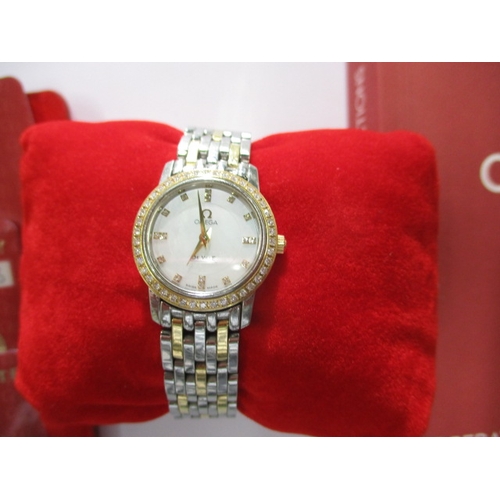 100 - A ladies Omega 1456 wrist watch, having diamond set bezel, in working order with box and all paperwo... 