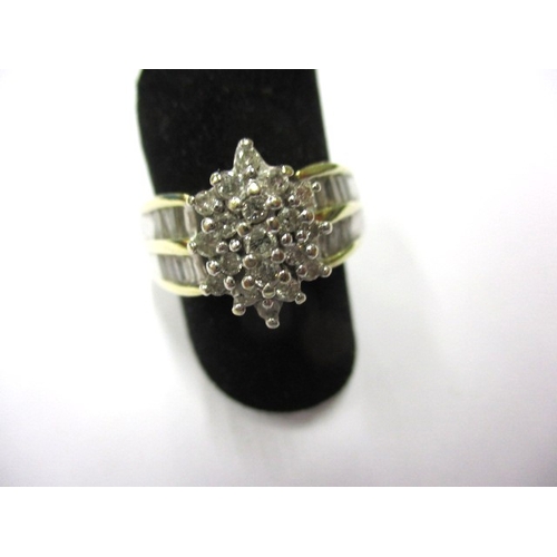 10 - An 18k? yellow gold diamond cluster ring with baguette cut diamonds to shoulders, approx. ring size ... 