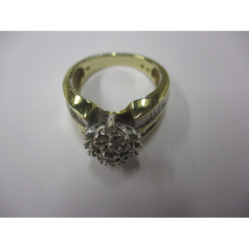 10 - An 18k? yellow gold diamond cluster ring with baguette cut diamonds to shoulders, approx. ring size ... 