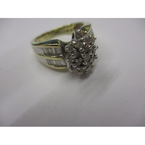 10 - An 18k? yellow gold diamond cluster ring with baguette cut diamonds to shoulders, approx. ring size ... 