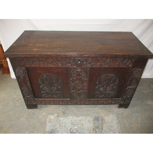 326 - An antique oak coffer with period carved front panel, general age related marks and repairs. Approxi... 