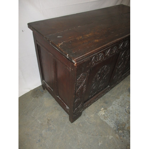 326 - An antique oak coffer with period carved front panel, general age related marks and repairs. Approxi... 