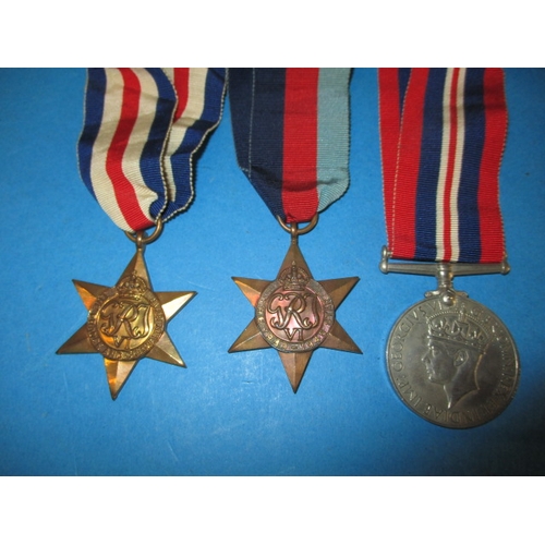 247 - A 1945 dated British Airborne RASC maroon Kangol beret with cap badge, medals and photo, all in used... 