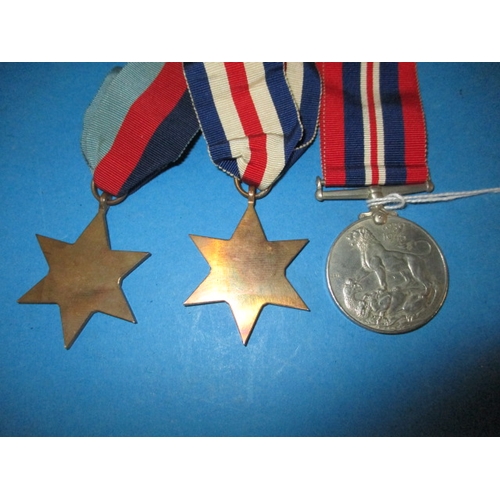 247 - A 1945 dated British Airborne RASC maroon Kangol beret with cap badge, medals and photo, all in used... 