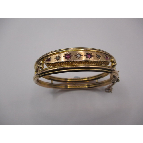 82 - A vintage 9ct gold, diamond and ruby bangle, approx. weight 15.7g, in good pre-owned condition with ... 