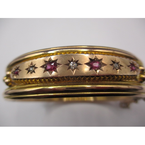 82 - A vintage 9ct gold, diamond and ruby bangle, approx. weight 15.7g, in good pre-owned condition with ... 