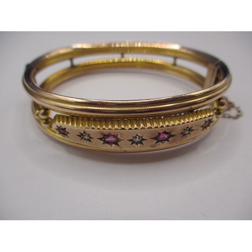 82 - A vintage 9ct gold, diamond and ruby bangle, approx. weight 15.7g, in good pre-owned condition with ... 