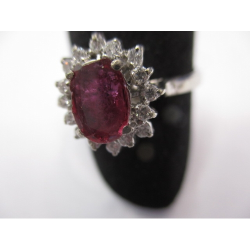 29 - A white gold diamond and ruby dress ring, approx. ring size ‘V’, approx. weight 3.8g in useable pre-... 