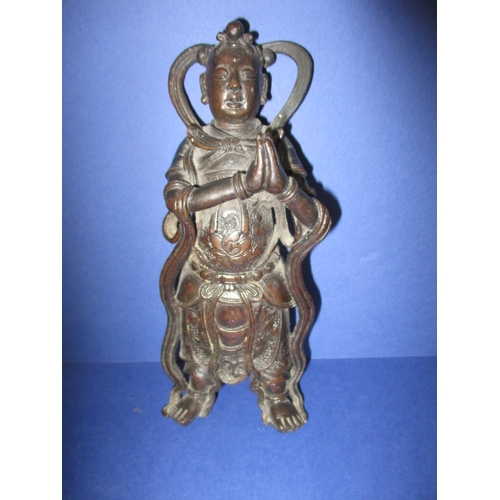 236 - An antique cast bronze figure of an oriental deity on carved wood stand, approx. height 26cm, having...