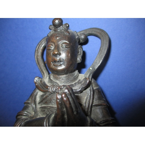 236 - An antique cast bronze figure of an oriental deity on carved wood stand, approx. height 26cm, having... 