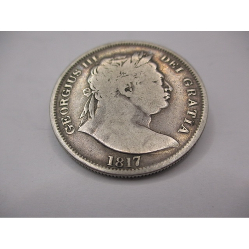 169 - A George III silver half crown dated 1817, a circulated coin with fine definition of features