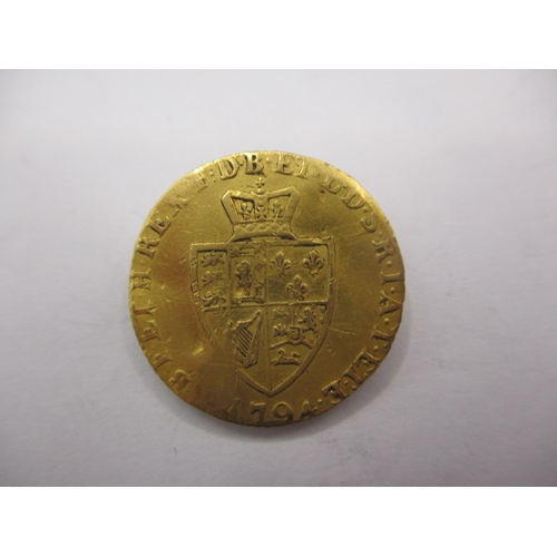 148 - A George III gold half spade guinea dated 1794, a circulated coin with reasonable definition of feat... 