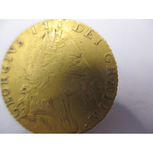 150 - A George III gold half spade guinea dated 1793 a circulated coin with fine definition of features, a... 