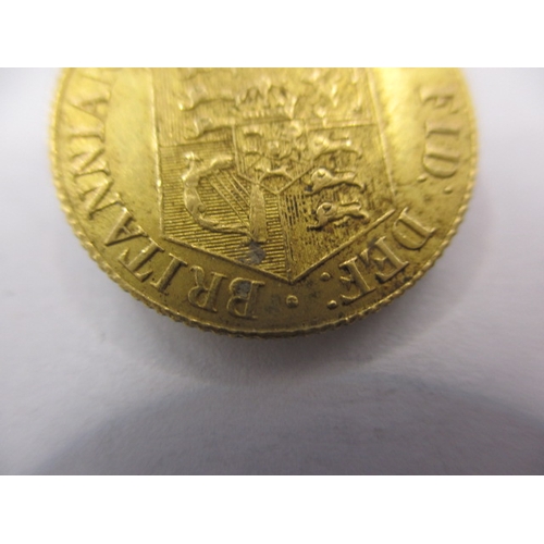 152 - A George III gold half sovereign dated 1818, a circulated coin with very fine definition of features