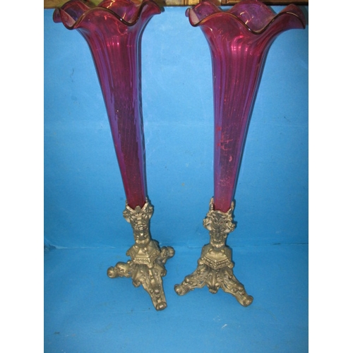 292 - A large pair of decorative vases, having cast metal bases and cranberry coloured glass trumpets, app... 