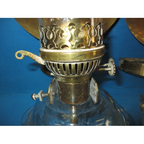 293 - Two vintage oil burning wall lights, with glass reservoirs and brass mounts, having use-related mark... 