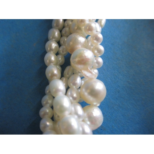 223 - A six strand baroque pearl necklace with 9ct gold clasp, approx. linear length 38cm, in good useable... 